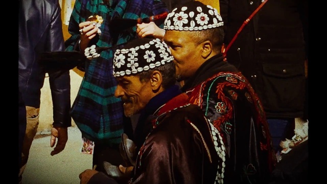 Video Reference: Outerwear, Temple, Interaction, Headgear, Event, Entertainment, Tradition, Jewellery, Fashion accessory, Ritual