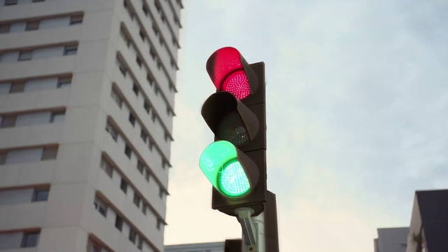 Video Reference: Sky, Building, Traffic light, Lighting, Tower block, signaling device, City, Gas, Metropolitan area, Tints and shades