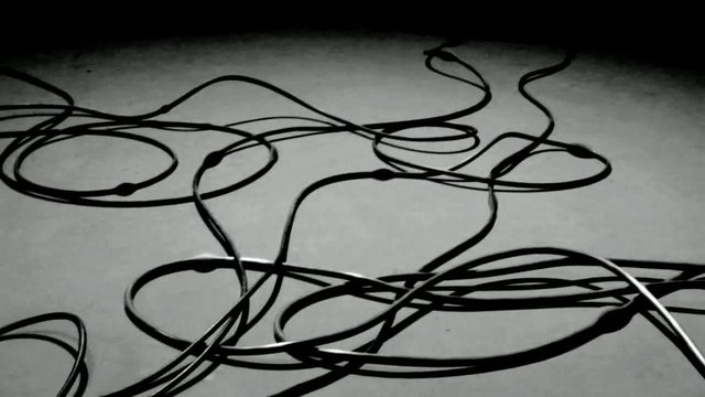 Video Reference: cables, wires, tangled, messy, abstract, monochrome, close-up, surface, tech, cords, entanglement, loops, background, disorder