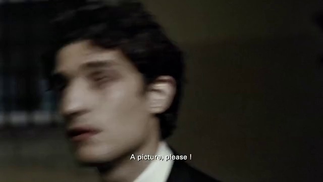 Video Reference: Forehead, Eyebrow, Eyelash, Jaw, Flash photography, Ear, Gesture, Facial hair, Formal wear, Smile