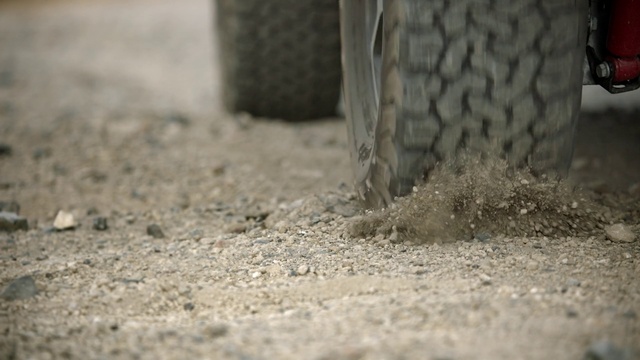 Video Reference: Automotive tire, Road surface, Grey, Asphalt, Tread, Grass, Wood, Trunk, Automotive wheel system, Human leg