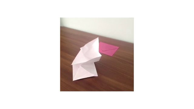 Video Reference: origami, paper craft, folded paper, envelope, tabletop, wooden table, handmade, craft, pink paper, white paper, simple background, indoor, still life