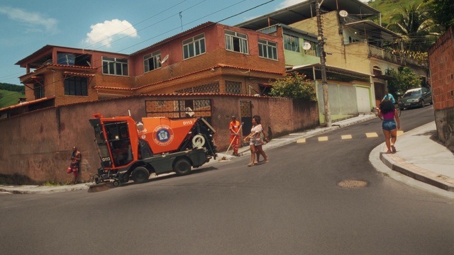 Video Reference: Building, Sky, Window, Vehicle, Wheel, Road surface, Asphalt, Tire, Motor vehicle, House