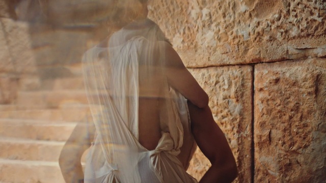 Video Reference: Sleeve, Beige, Wood, Flash photography, Human leg, Brick, Shadow, Ancient history, Sitting, Bridal accessory