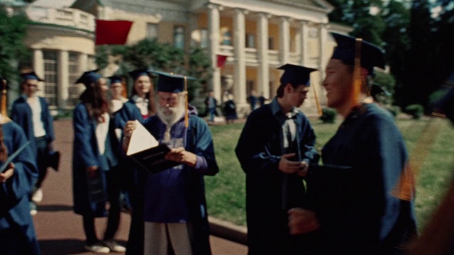 Video Reference: Academic dress, Mortarboard, Scholar, Hat, Gesture, Headgear, Graduation, Plant, Building, Public space