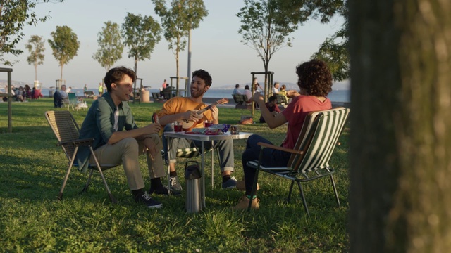 Video Reference: Furniture, Table, Chair, Sky, Plant, Tree, Outdoor furniture, Shade, Grass, Leisure