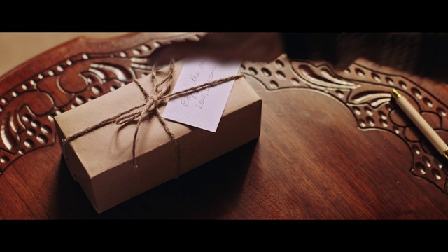 Video Reference: Brown, Rectangle, Triangle, Font, Material property, Gift wrapping, Wood, Box, Packaging and labeling, Carton