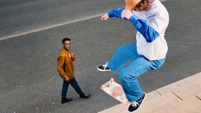 Video Reference: Clothing, Footwear, Jeans, Shoe, Leg, Street fashion, Gesture, Yellow, Sneakers, Hat