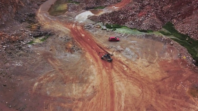 Video Reference: Tire, Plant, Wood, Vehicle, Bedrock, Grass, Tree, Car, Slope, Landscape