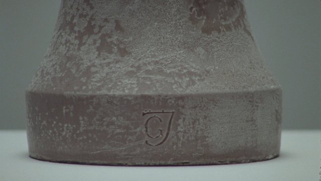 Video Reference: bottle, metal, frosted, close-up, container, logo, engraving, product, still life, minimal, macro, textured, gray, plain background