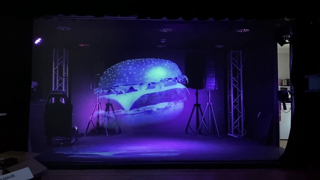 Video Reference: Purple, World, Performing arts, Entertainment, Sky, Projection screen, Display device, Music venue, Electronic device, Magenta