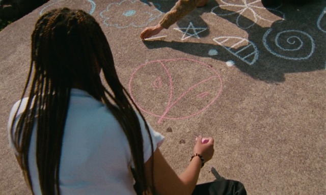 Video Reference: Wood, Gesture, Road surface, Asphalt, Art, Tree, Tints and shades, Chalk, Grass, Sidewalk