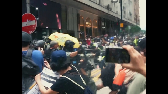 Video Reference: Hat, Public space, Crowd, Motor vehicle, Baseball cap, Cameras & optics, Window, City, T-shirt, Cap