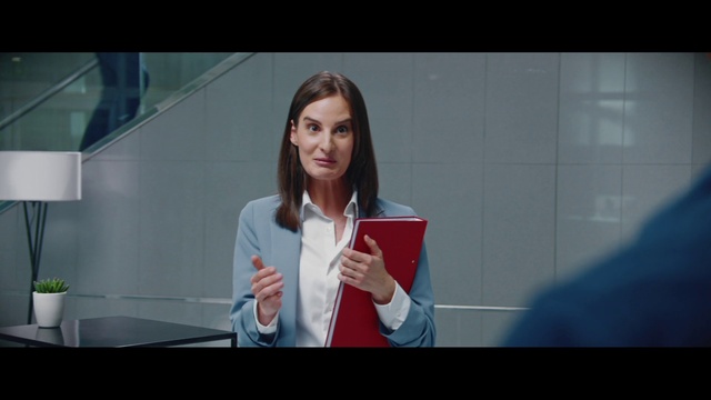 Video Reference: Television presenter, Microphone, Gesture, Spokesperson, Gadget, Display device, Street fashion, White-collar worker, Electronic device, Event