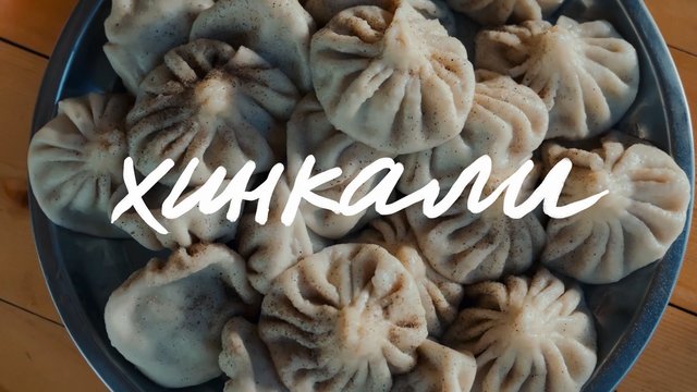 Video Reference: dumplings, momos, steamed, food, bowl, top view, pepper, homemade, cuisine, snack, savory, wooden table, text overlay, handwritten