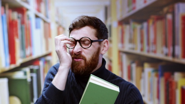 Video Reference: Glasses, Chin, Bookcase, Vision care, Shelf, Beard, Eyewear, Publication, Book, Smile