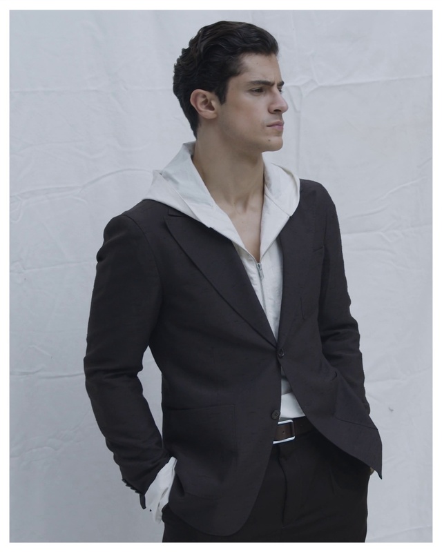 Video Reference: Dress shirt, Neck, Sleeve, Gesture, Collar, Grey, Waist, Street fashion, Blazer, Fashion design