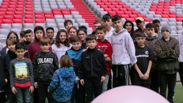 Video Reference: Shirt, White, Human, Smile, T-shirt, Red, Crowd, Leisure, Competition event, Team