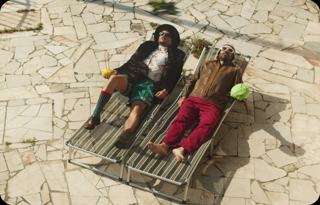 Video Reference: Photograph, Shorts, Leisure, Adaptation, Travel, Urban design, Sitting, Sandal, Foot, Fun