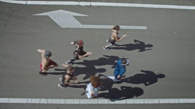 Video Reference: Asphalt, Road surface, Leisure, Recreation, Road, Event, Pedestrian, City, Shadow, Fun
