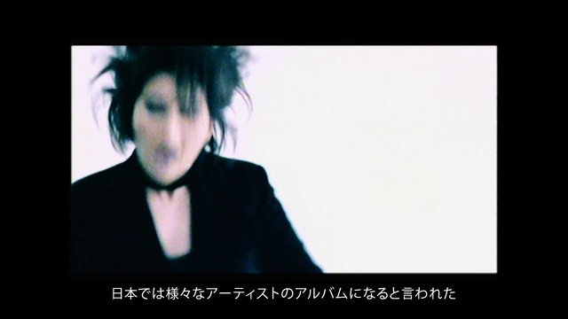 Video Reference: Flash photography, Jaw, Gesture, Eyelash, Font, Technology, Display device, Movie, Formal wear, Darkness