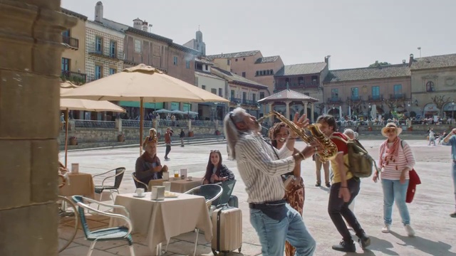 Video Reference: Jeans, Sky, Building, Table, Chair, Window, Musical instrument, Shade, Leisure, Outdoor furniture