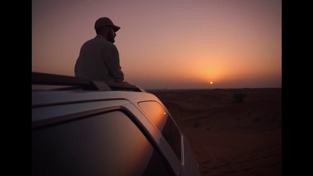 Video Reference: Sky, Atmosphere, Car, Ecoregion, Cloud, Vehicle, Flash photography, Dusk, Hat, Fedora