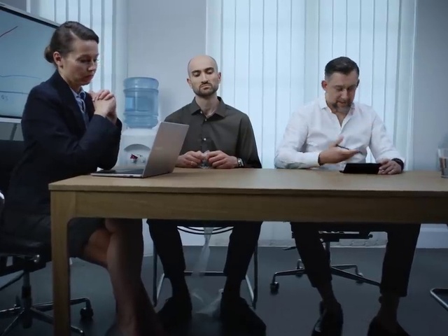 Video Reference: Table, Laptop, Computer, Conference room table, Desk, Tie, Interaction, Chair, Event, Technology