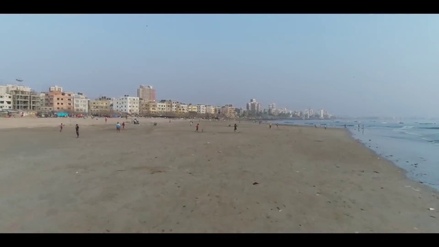 Video Reference: Water, Sky, Beach, People on beach, Fluid, Body of water, Coastal and oceanic landforms, Building, Atmospheric phenomenon, Horizon