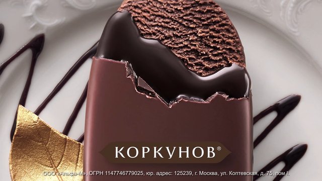 Video Reference: chocolate, dessert, ice cream bar, sweet, close-up, food, confectionery, drizzle, gold leaf, cyrillic text, packaging, brand, plate, indulgent, macro, frozen dessert