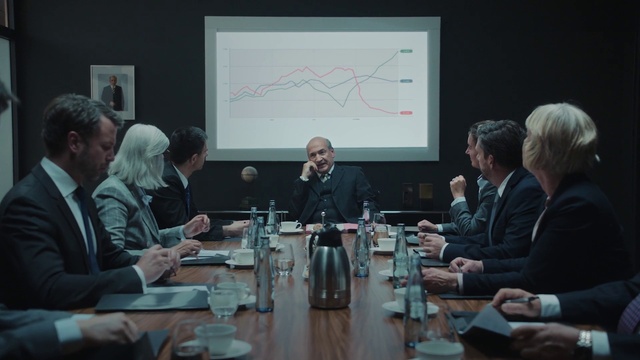 Video Reference: Table, Coat, Human, Organism, Suit, Interaction, Tableware, Social group, Bottle, Chair