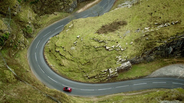 Video Reference: Plant, Road surface, Natural landscape, Asphalt, Slope, Highland, Thoroughfare, Grass, Road, Groundcover
