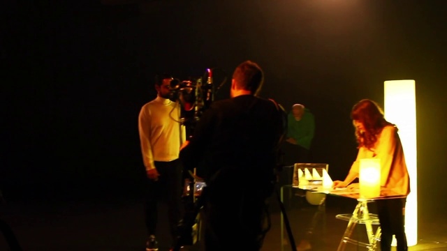 Video Reference: Lighting, Orange, Musician, Music, Performing arts, Entertainment, Event, Art, T-shirt, Darkness