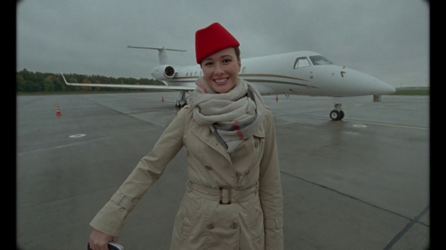 Video Reference: Smile, Sky, Aircraft, Airplane, Vehicle, Aviation, Gesture, Aerospace manufacturer, Air travel, Jacket