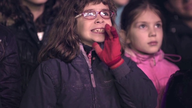 Video Reference: Face, Hair, Glasses, Lip, Outerwear, Vision care, Smile, Purple, Flash photography, Gesture