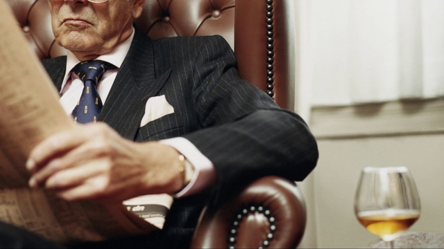 Video Reference: Glasses, Tie, Dress shirt, Coat, Gesture, Suit, Collar, Tableware, Audio equipment, Blazer