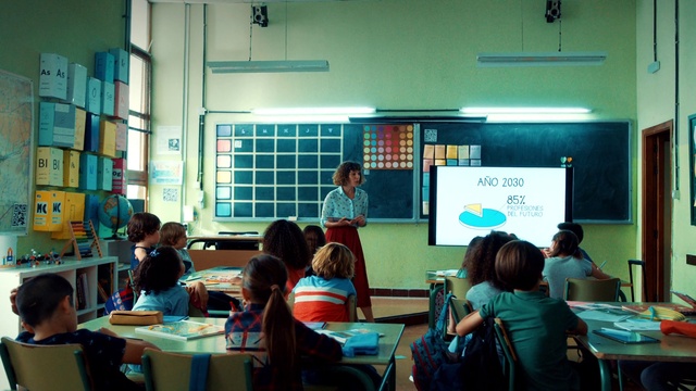 Video Reference: Table, Furniture, Green, Chair, Desk, Building, Academic institution, Teacher, Class, Event