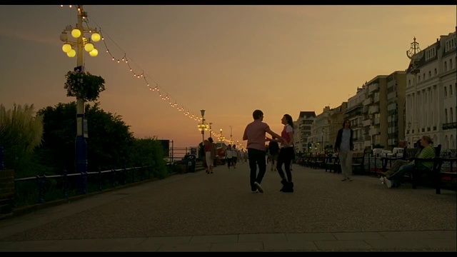 Video Reference: Sky, Daytime, Building, Infrastructure, Road surface, Street light, Architecture, Sunlight, Gesture, Asphalt