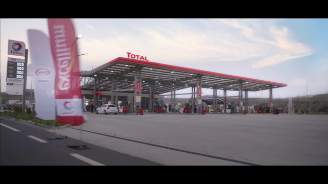 Video Reference: Cloud, Sky, Asphalt, Car, Vehicle, Gas, Shade, City, Logo, Road