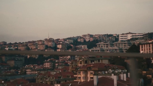 Video Reference: Brown, Sky, Atmosphere, Building, Window, Dusk, Cityscape, Horizon, Urban design, Neighbourhood