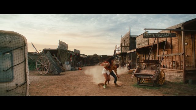 Video Reference: western, old west, street set, dust, running, cowboy town, wooden buildings, sunset, action, outdoor, period set, village, rustic, drama, two people