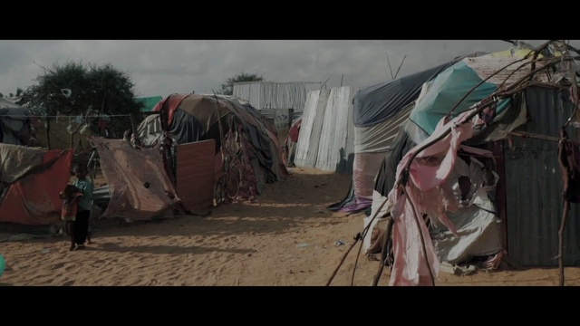 Video Reference: Tent, Sky, Landscape, Tints and shades, Tree, Event, Sand, Soil, Visual arts, Village