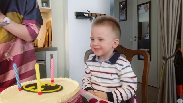 Video Reference: Smile, Candle, Birthday candle, Food, Birthday party, Toddler, Chair, Child, T-shirt, Baby