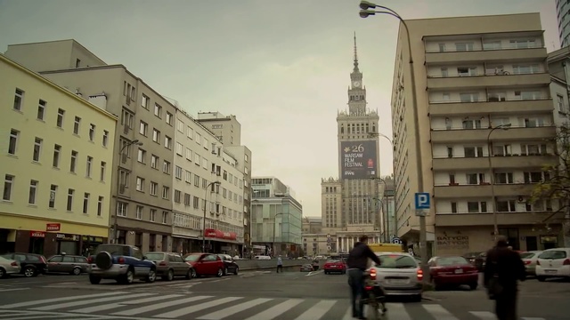 Video Reference: Car, Sky, Building, Wheel, Daytime, Vehicle, Tire, Window, Cloud, Infrastructure