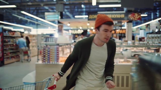 Video Reference: Cap, Shopping cart, Sleeve, Street fashion, Baseball cap, Customer, Fun, T-shirt, Retail, Sportswear