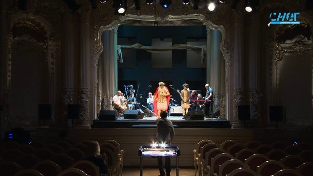 Video Reference: Dress, Musical instrument accessory, Entertainment, Building, Performing arts, Chair, Suit, Curtain, Event, Music venue