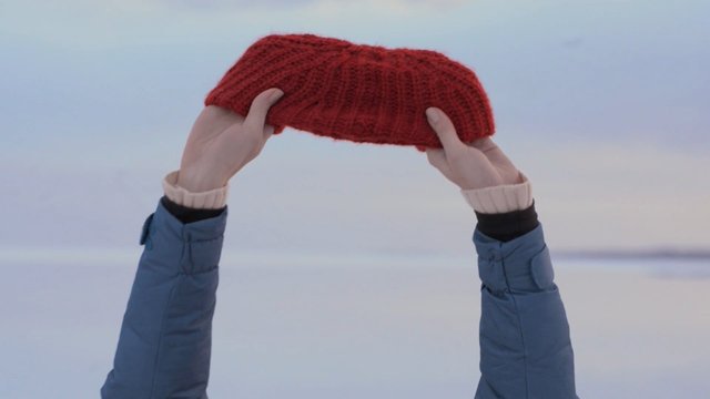 Video Reference: hands, hat, knitted, red, winter, jacket, snow, outdoors, cold, close-up, textile, seasonal, landscape, minimal