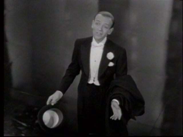 Video Reference: Suit trousers, Coat, Gesture, Flash photography, Suit, Blazer, Formal wear, Vintage clothing, Event, Collar