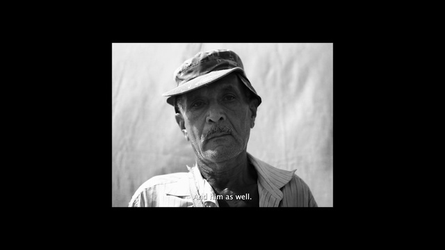 Video Reference: Hat, Flash photography, Sleeve, Gesture, Black-and-white, Font, Darkness, Monochrome photography, Cap, Movie