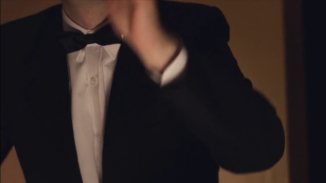 Video Reference: Dress shirt, Neck, Sleeve, Gesture, Flash photography, Collar, Blazer, Suit, Formal wear, Button
